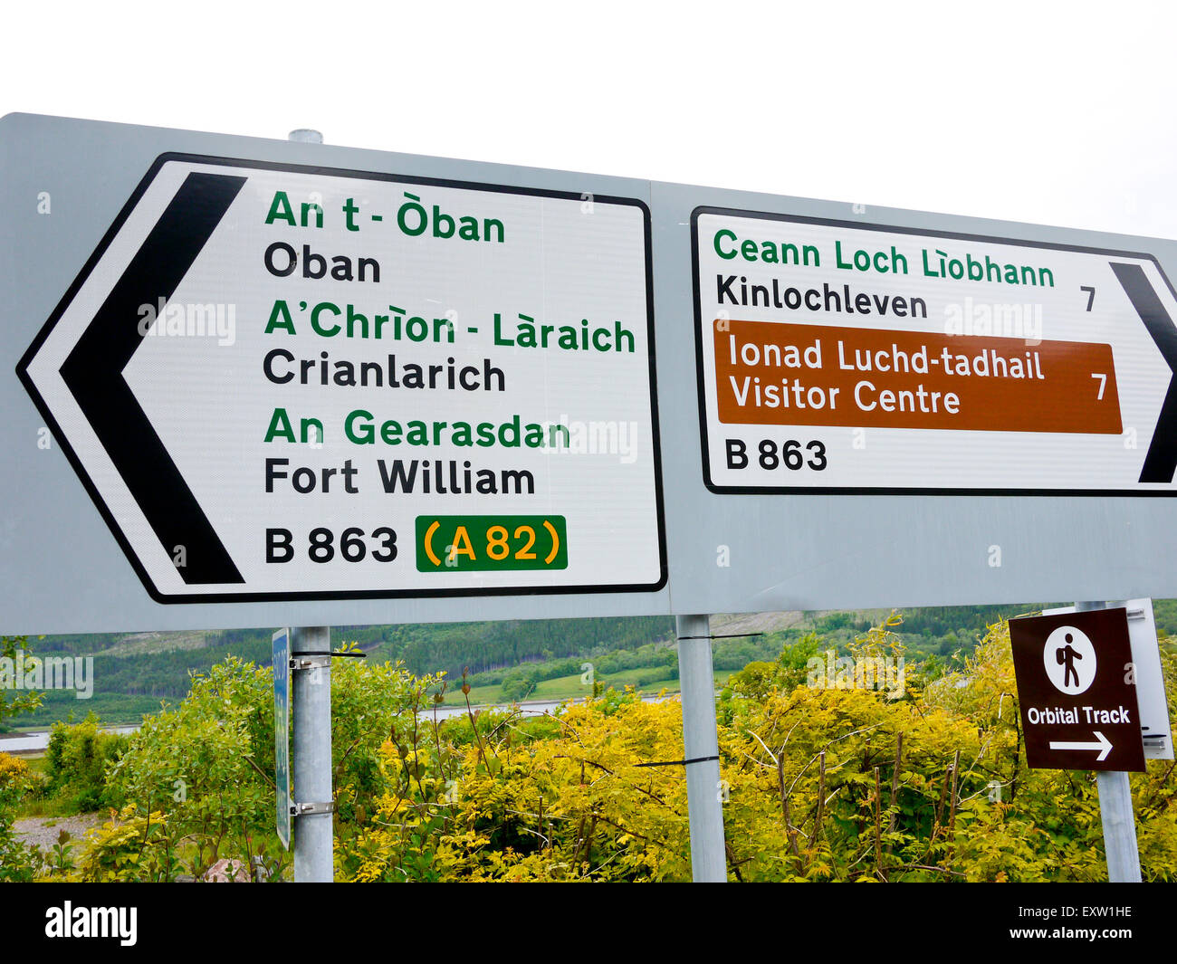 Direction sign post in Scotland in Gaelic and English, Scotland, UK. Stock Photo