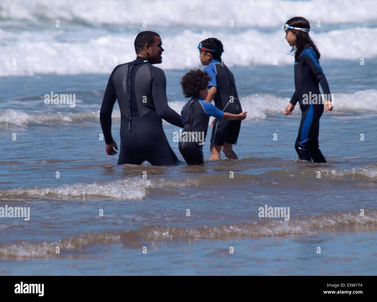 Family playing in the sea together, Woolacombe, Devon, UK Stock Photo