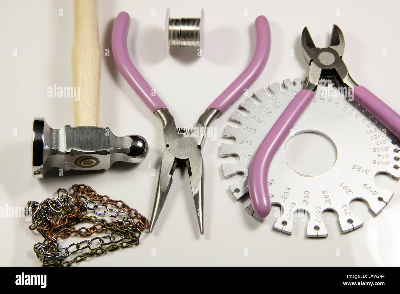Various craft tools used to make jewelry from wire and beads Stock Photo