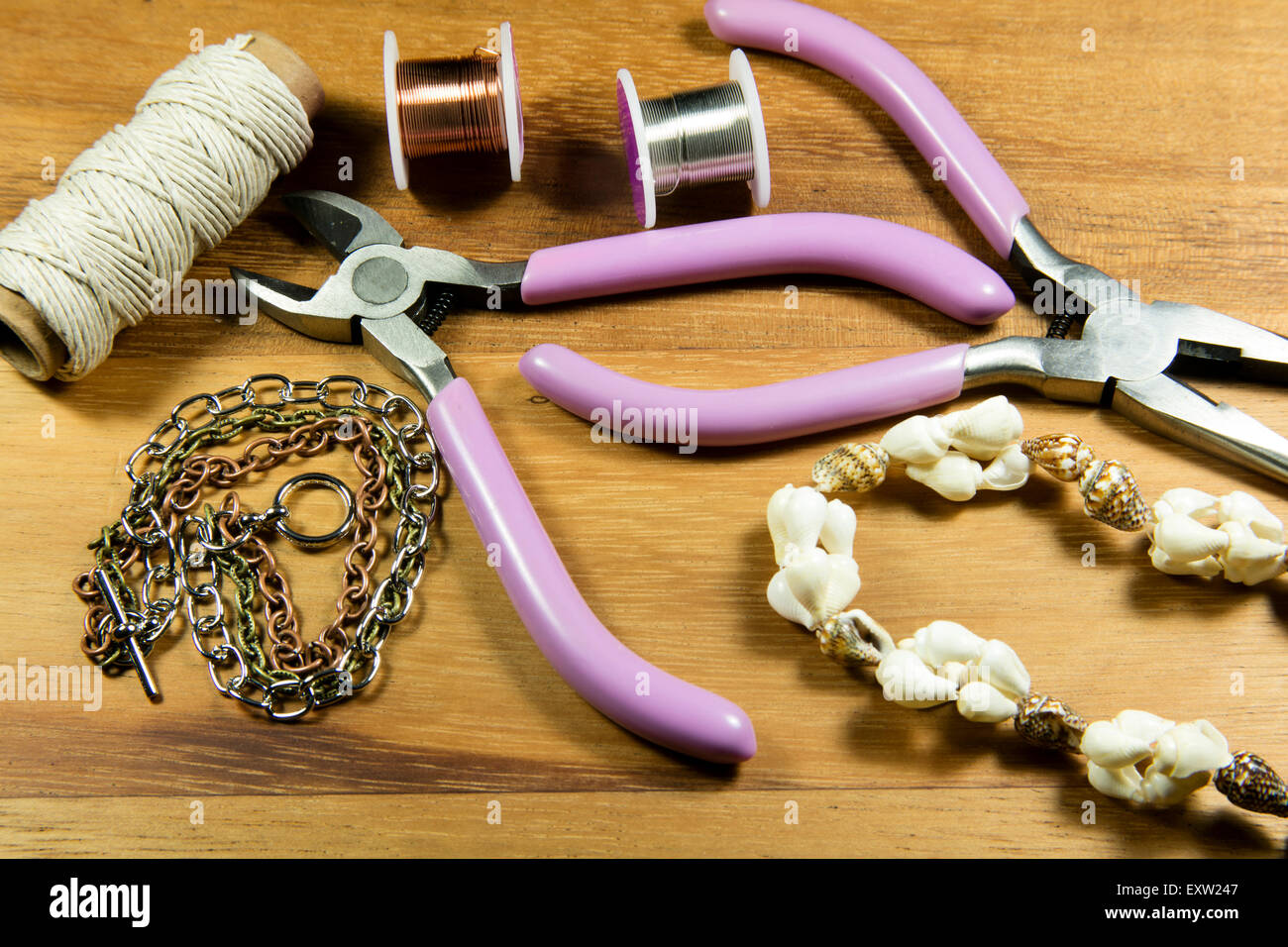 Various craft tools used to make jewelry from wire and beads Stock Photo
