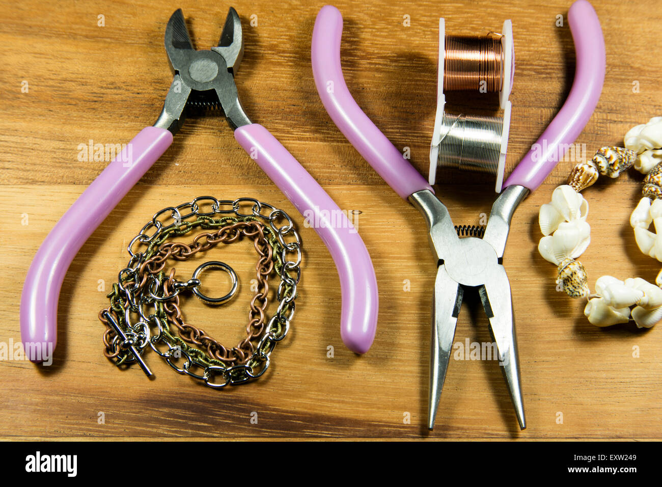 Various craft tools used to make jewelry from wire and beads Stock Photo