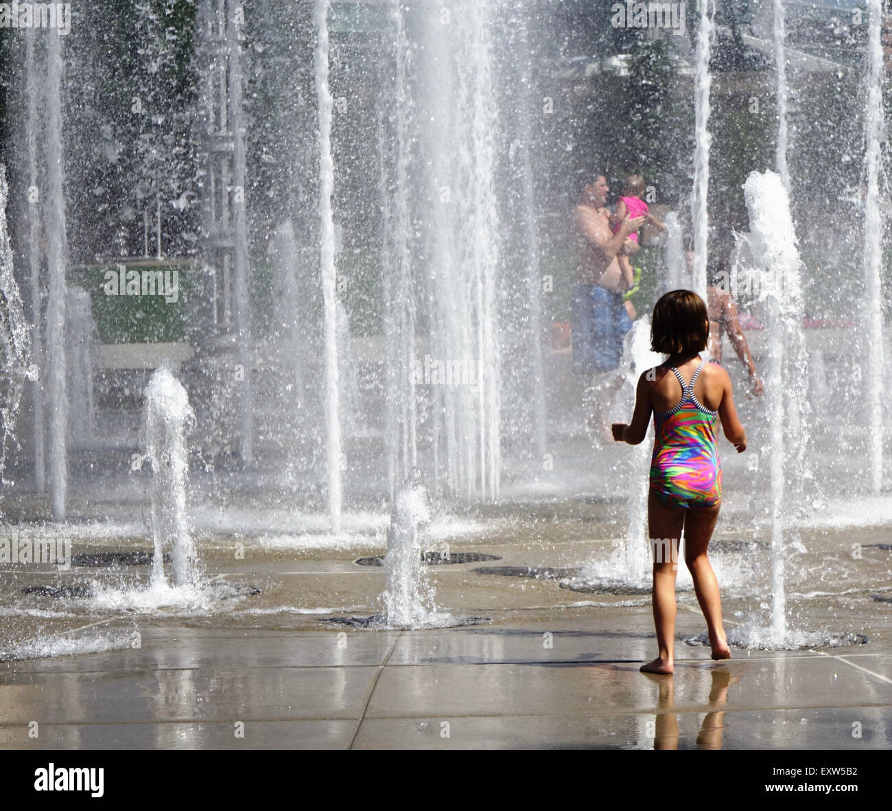 Children and adults play in the water fountains in World's fair park ...