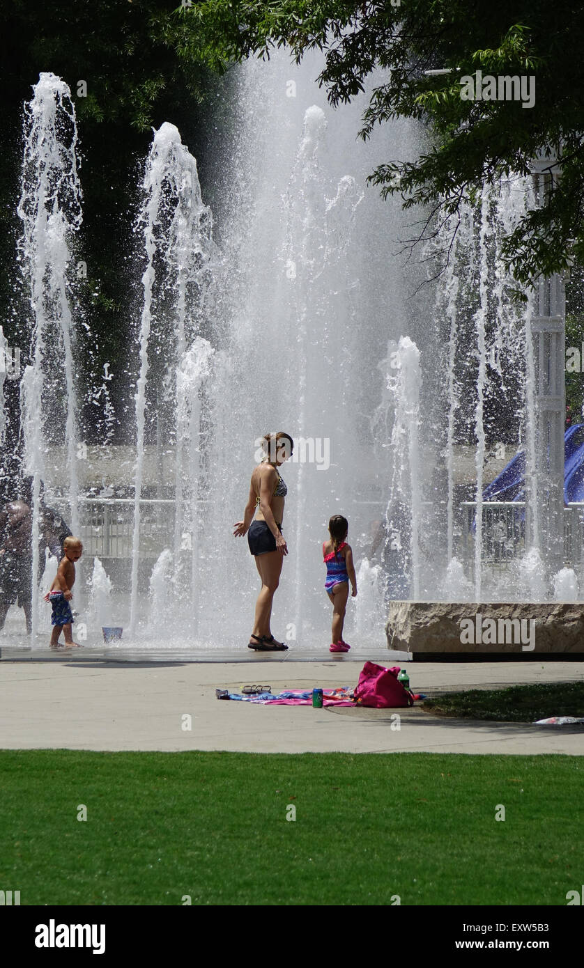 Children and adults play in the water fountains in World's fair park