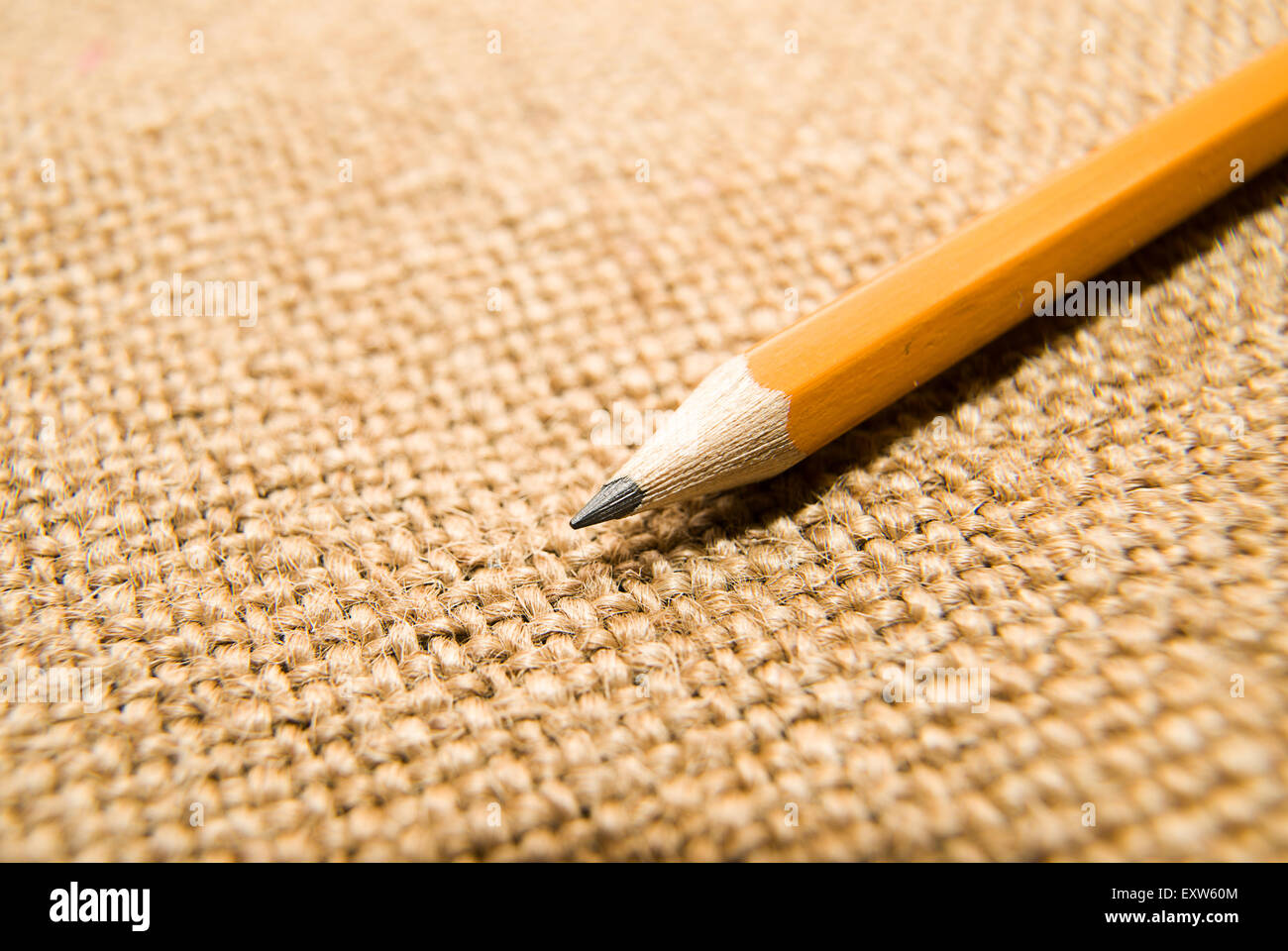 Yellow wooden pencil for drawing on old cloth Stock Photo - Alamy