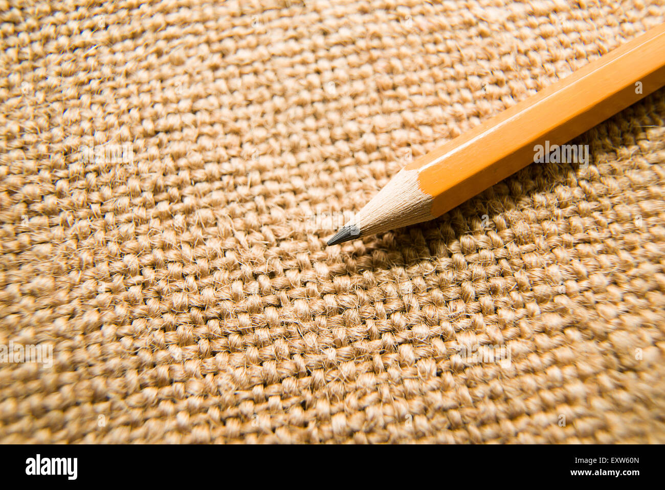 Yellow wooden pencil for drawing on old cloth Stock Photo - Alamy