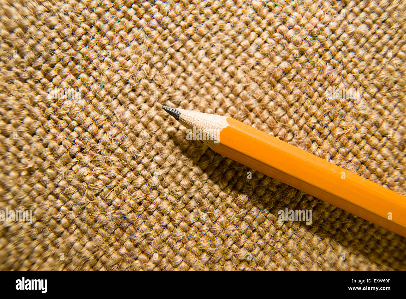 Yellow wooden pencil for drawing on old cloth Stock Photo - Alamy