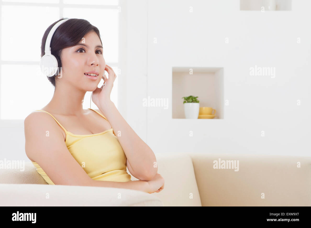 Young woman looking away with head phone and smiling, Stock Photo