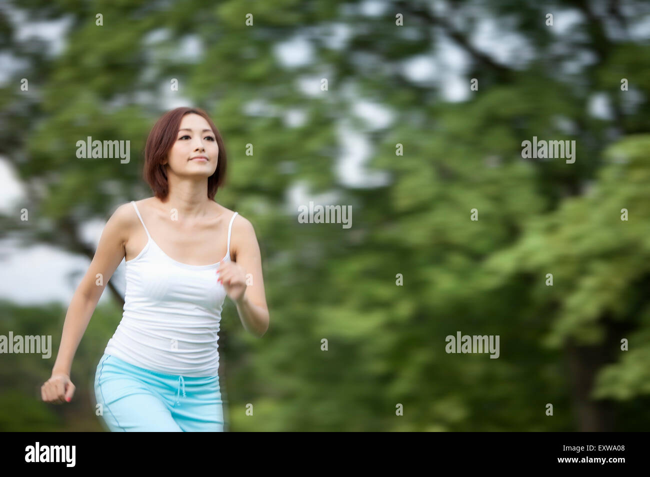 Young woman running and looking away, Stock Photo
