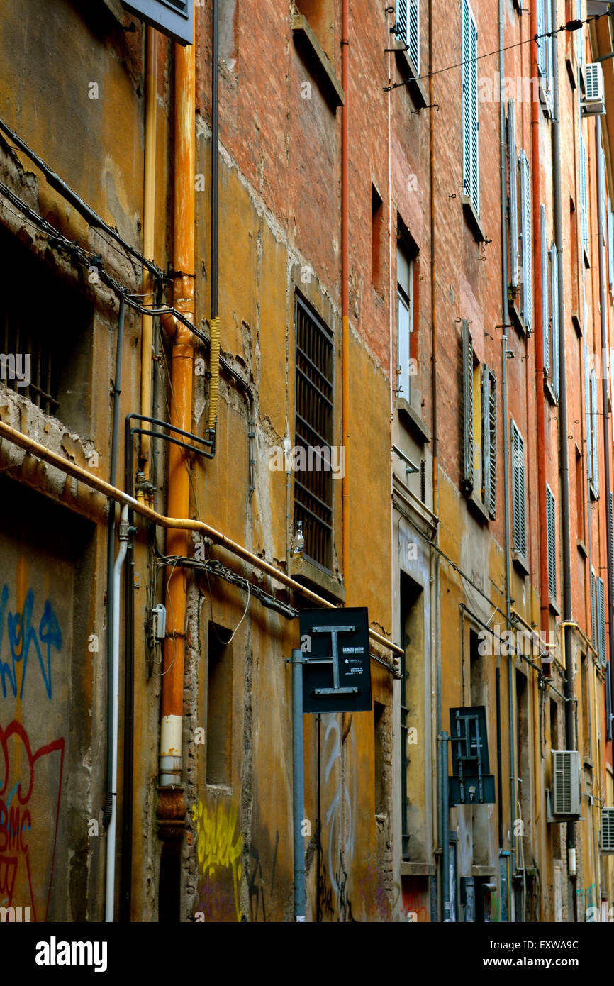 narrow street in Bologna, the capital city of the Emilia Romagna region in Italy. The city is characterized by the color red Stock Photo