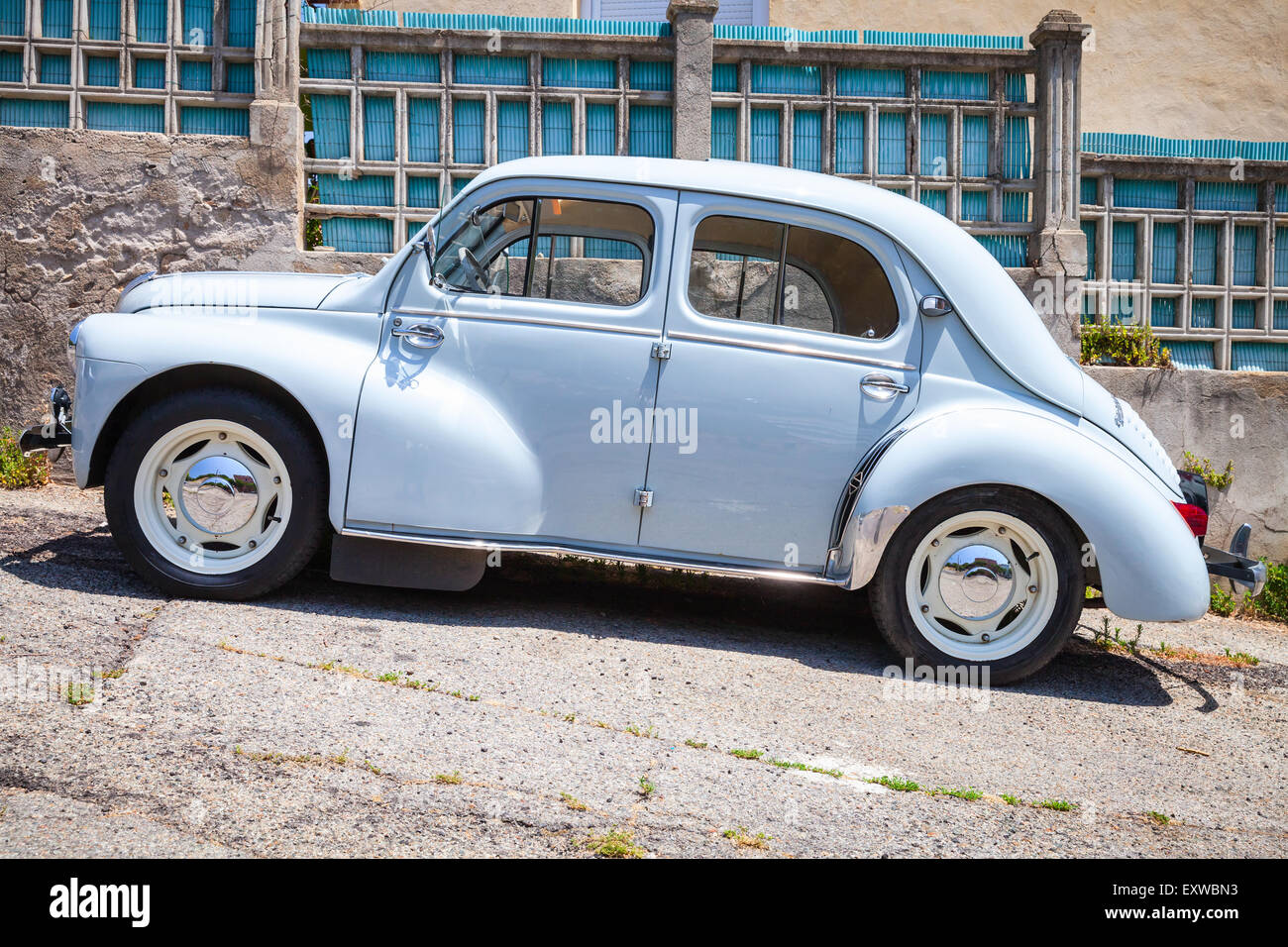 Ajaccio, France - July 6, 2015: Light blue Renault 4CV old-timer economy car stands parked on a roadside in French town, side vi Stock Photo