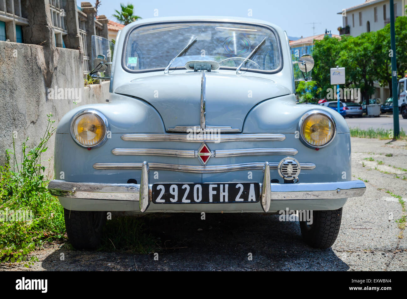 Ajaccio, France - July 6, 2015: Light blue Renault 4CV old-timer economy car stands parked on a roadside in French town, front v Stock Photo