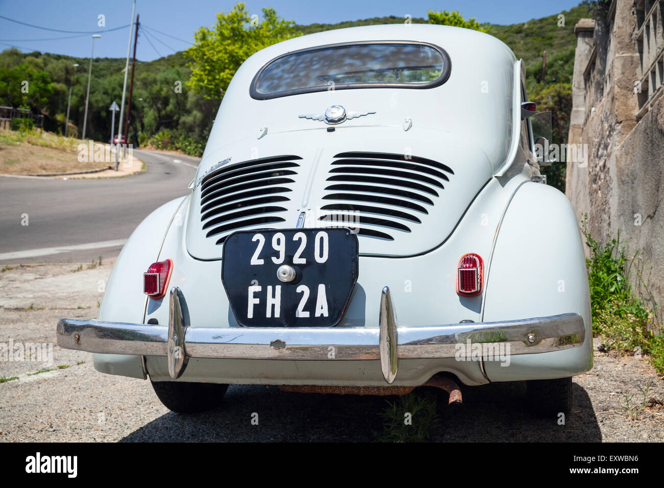 Ajaccio, France - July 6, 2015: Light blue Renault 4CV old-timer economy car stands parked on a roadside in French town, closeup Stock Photo