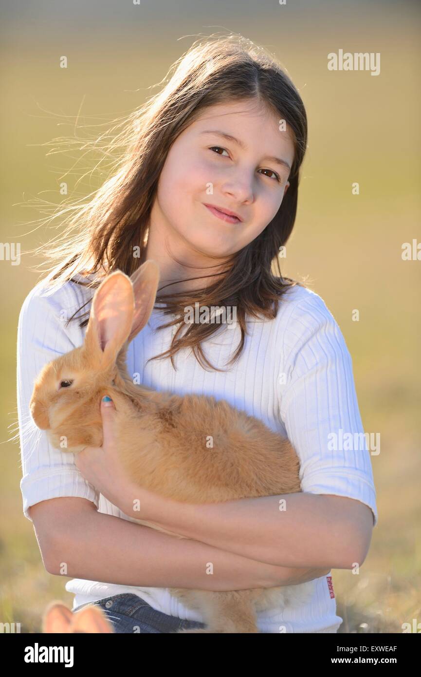 Teenage girl with her rabbit on a meadow, Upper Palatinate, Bavaria, Germany, Europe Stock Photo