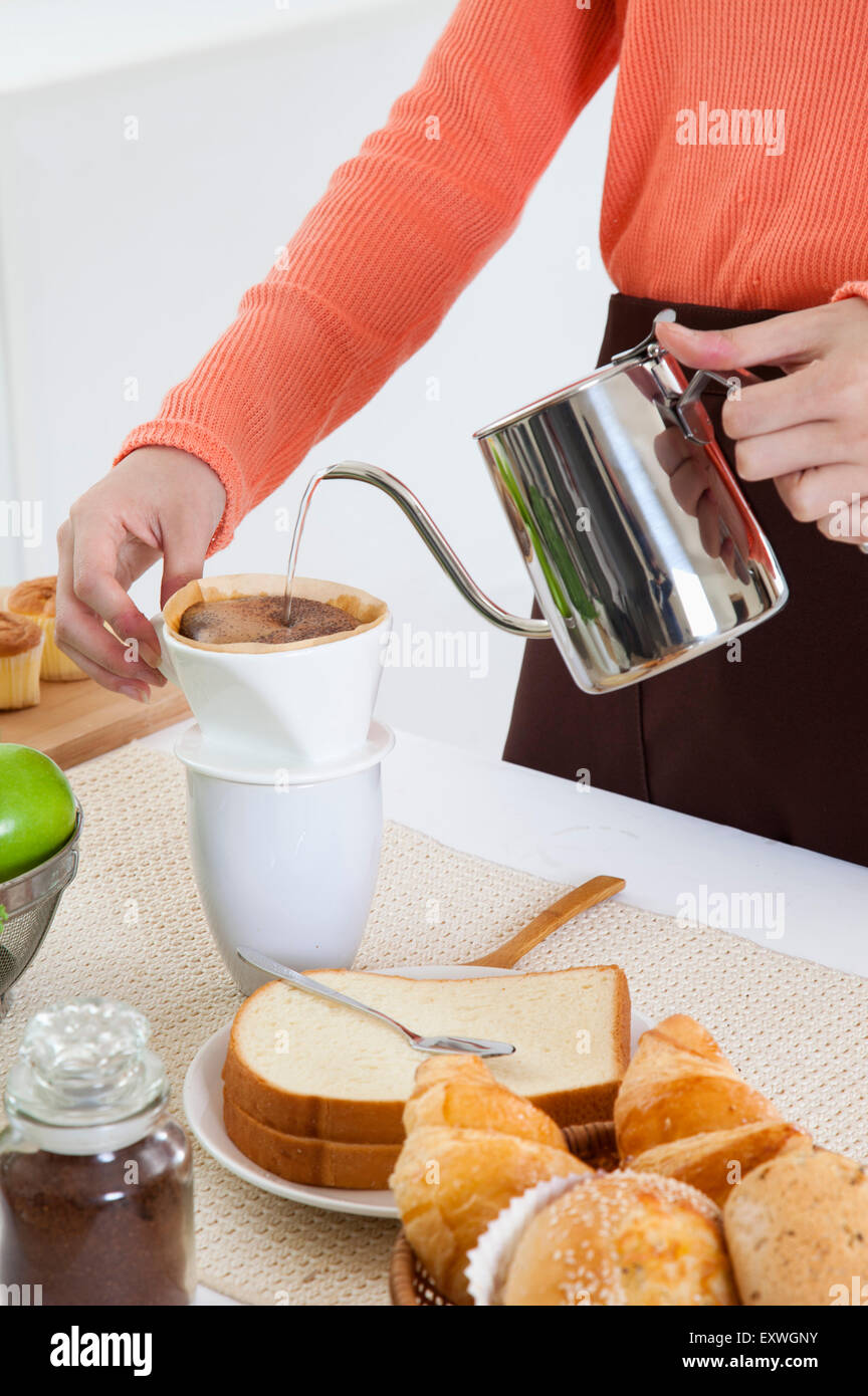 Young woman making coffee in the kitchen Stock Photo Alamy