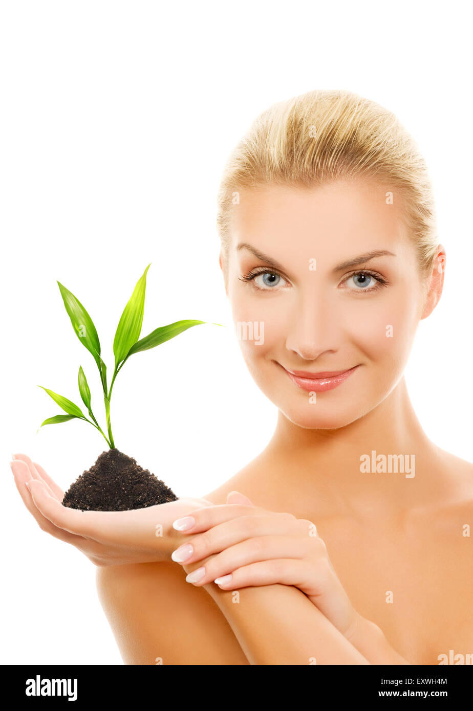 Beautiful blond woman holding young plant Stock Photo - Alamy