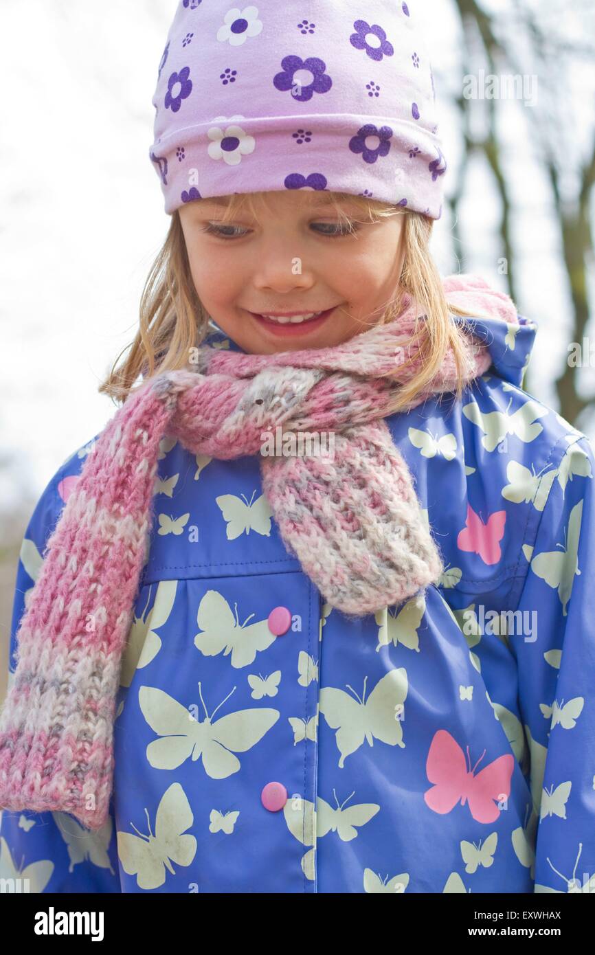 Girl with cap, scarf and rain jacket Stock Photo