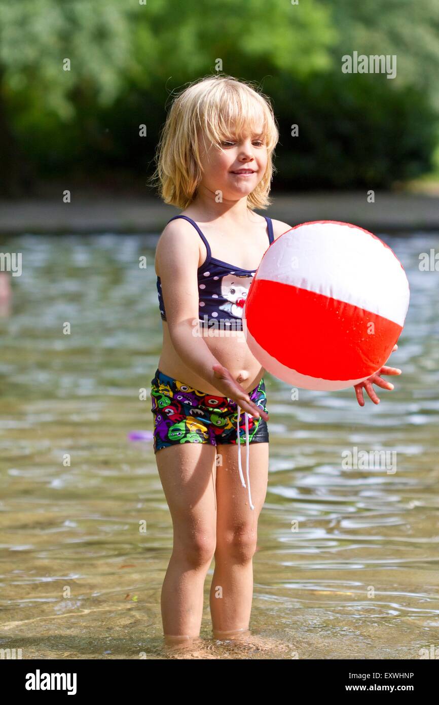 Girl playing in lake Stock Photo