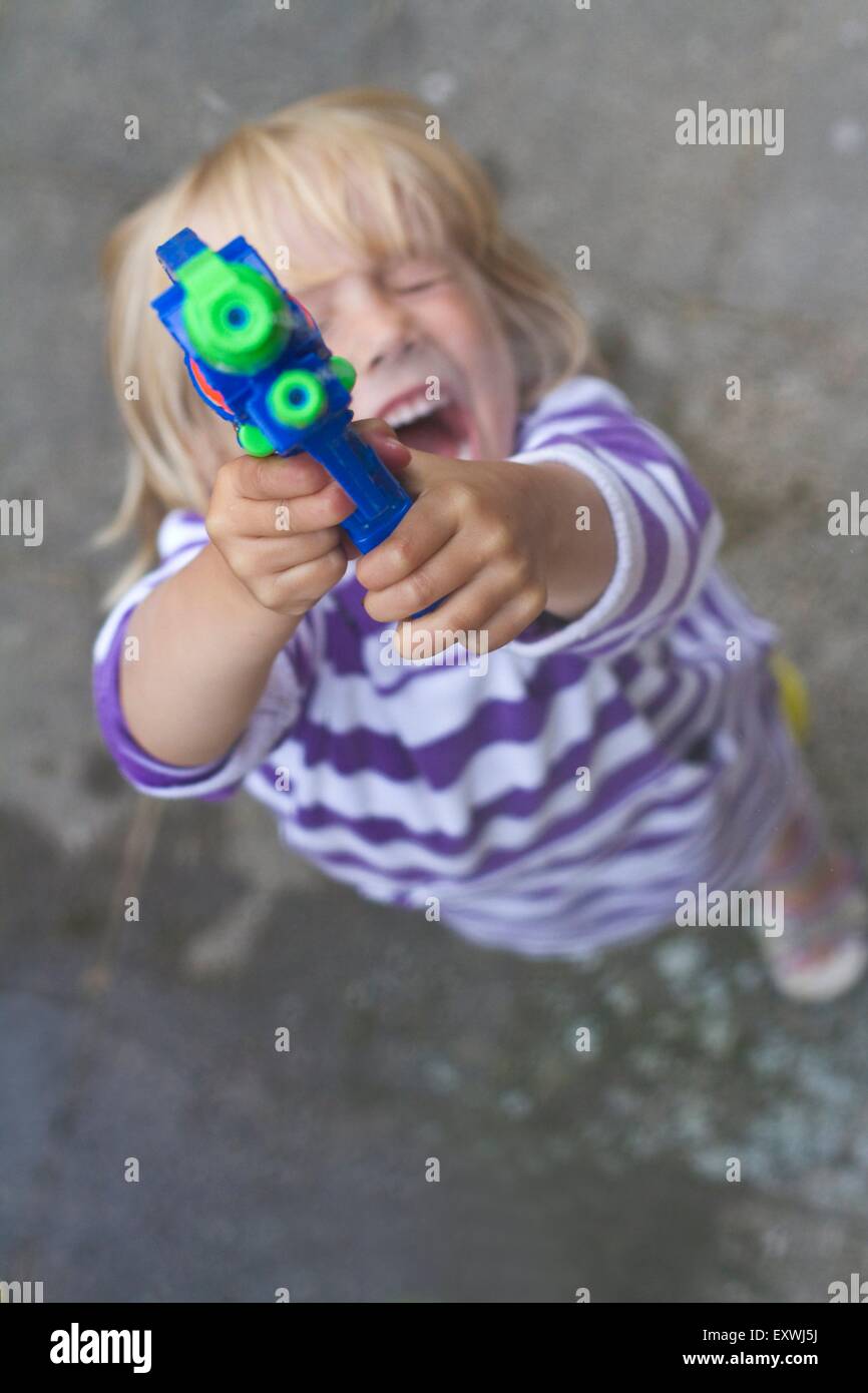 Girl with a water pistol Stock Photo