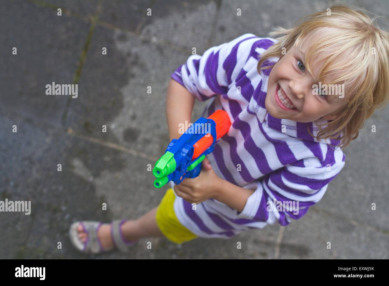 Girl with a water pistol Stock Photo