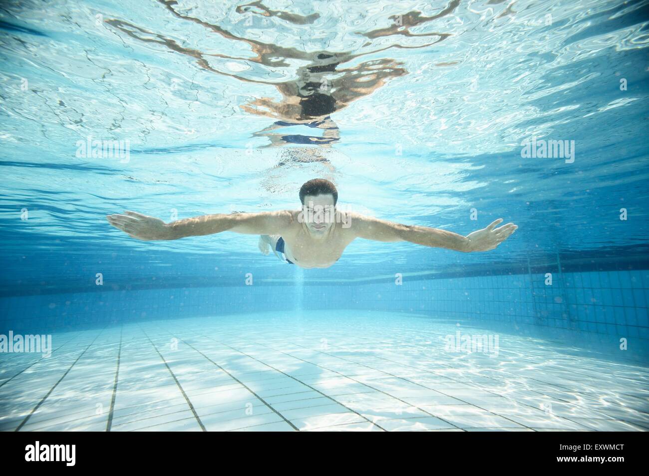 Man swimming under water in an open-air bath Stock Photo