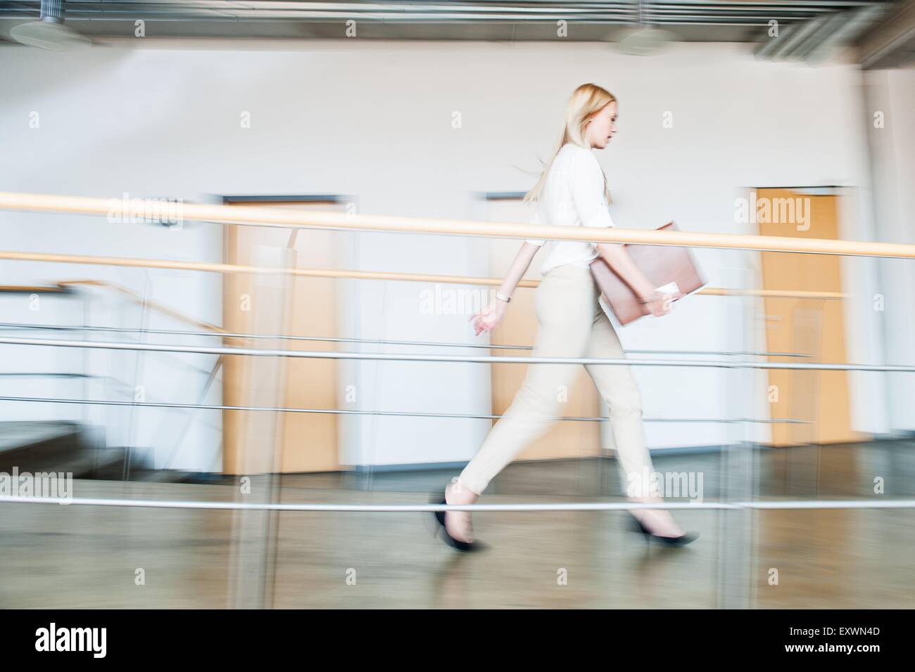 Young woman in a hurry in office Stock Photo