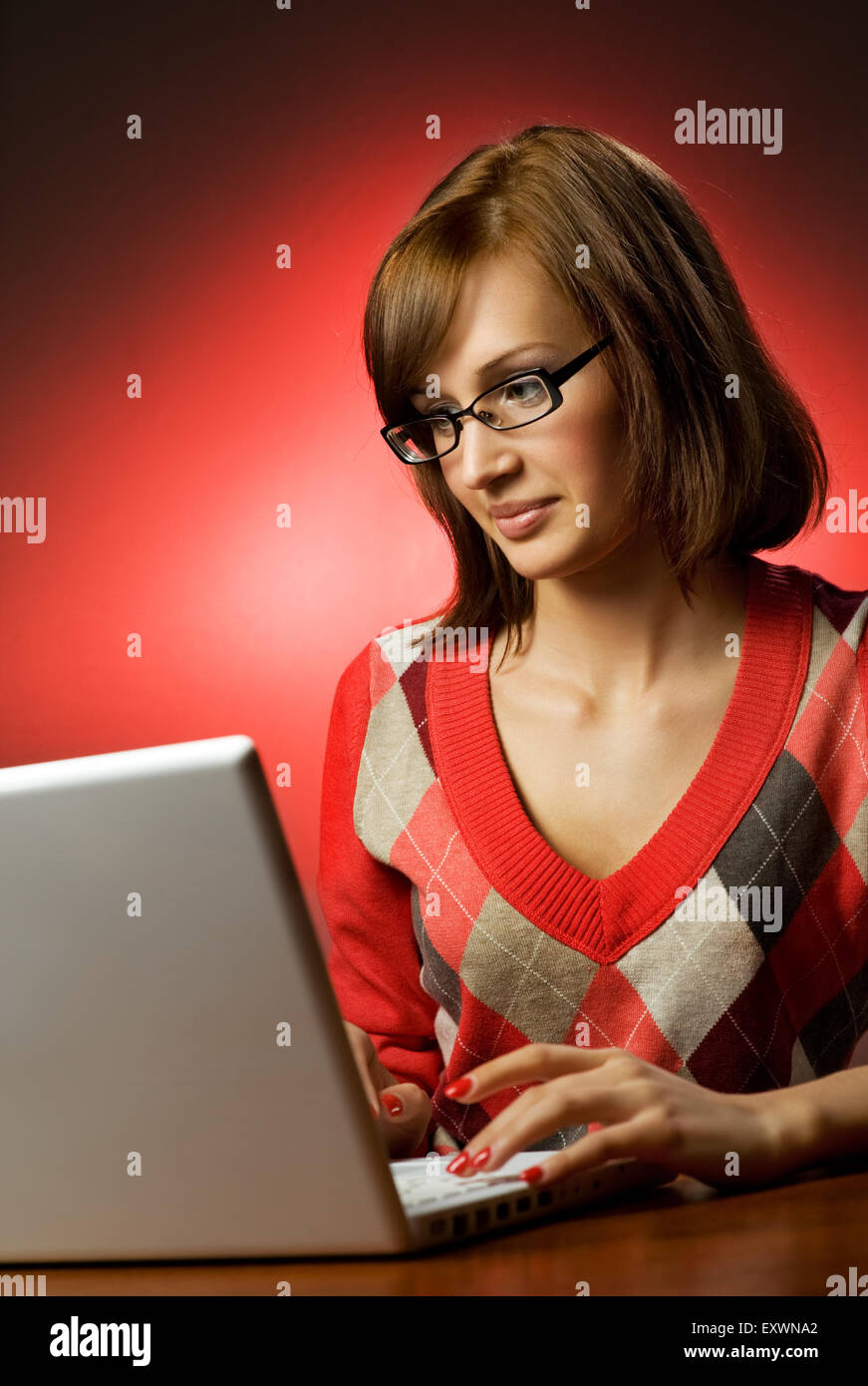 Beautiful young woman working on her laptop Stock Photo - Alamy