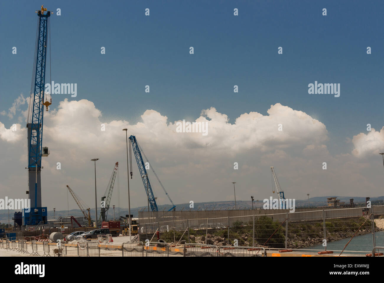 Silhouettes of construction cranes in the sky Stock Photo - Alamy