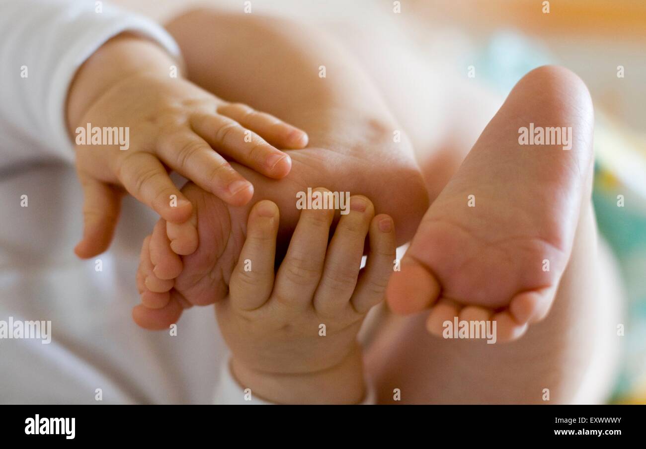 Baby playing with hands and feet Stock Photo - Alamy