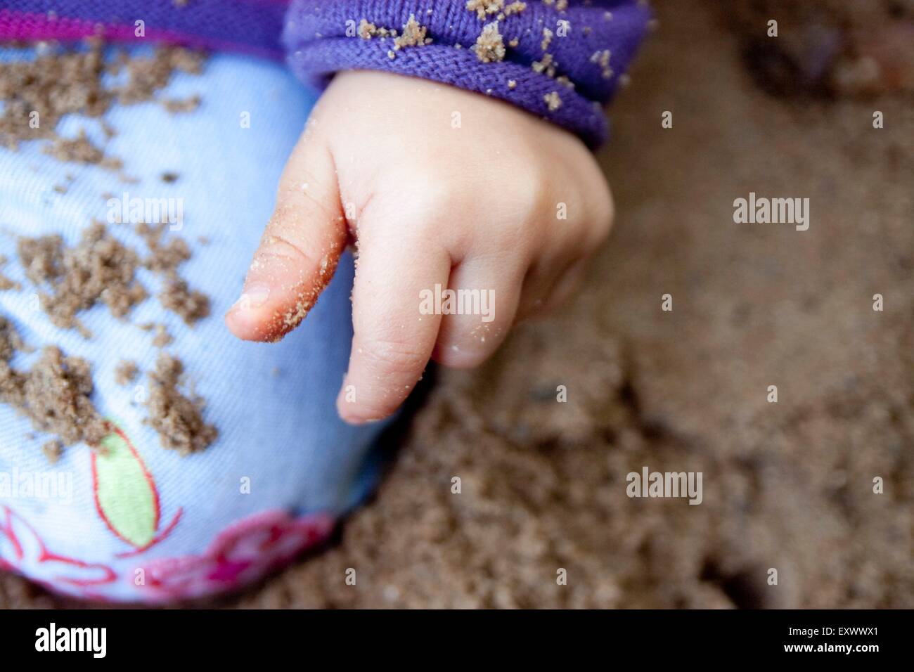 Girl playing in sandpit Stock Photo