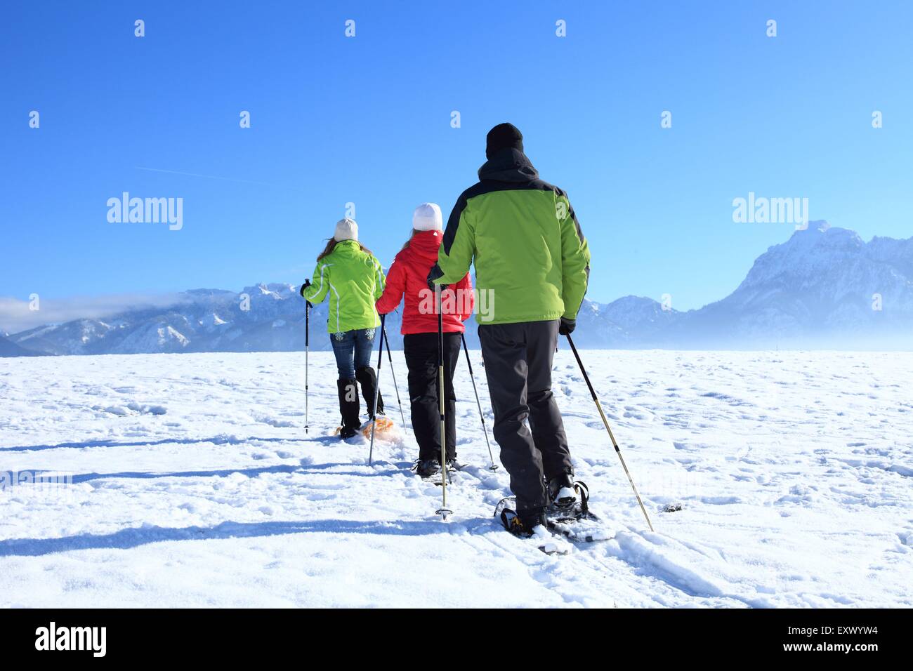 Three persons with snow shoes, Tegelberg, Ammergau Alps, Allgaeu, Bavaria, Germany, Europe Stock Photo