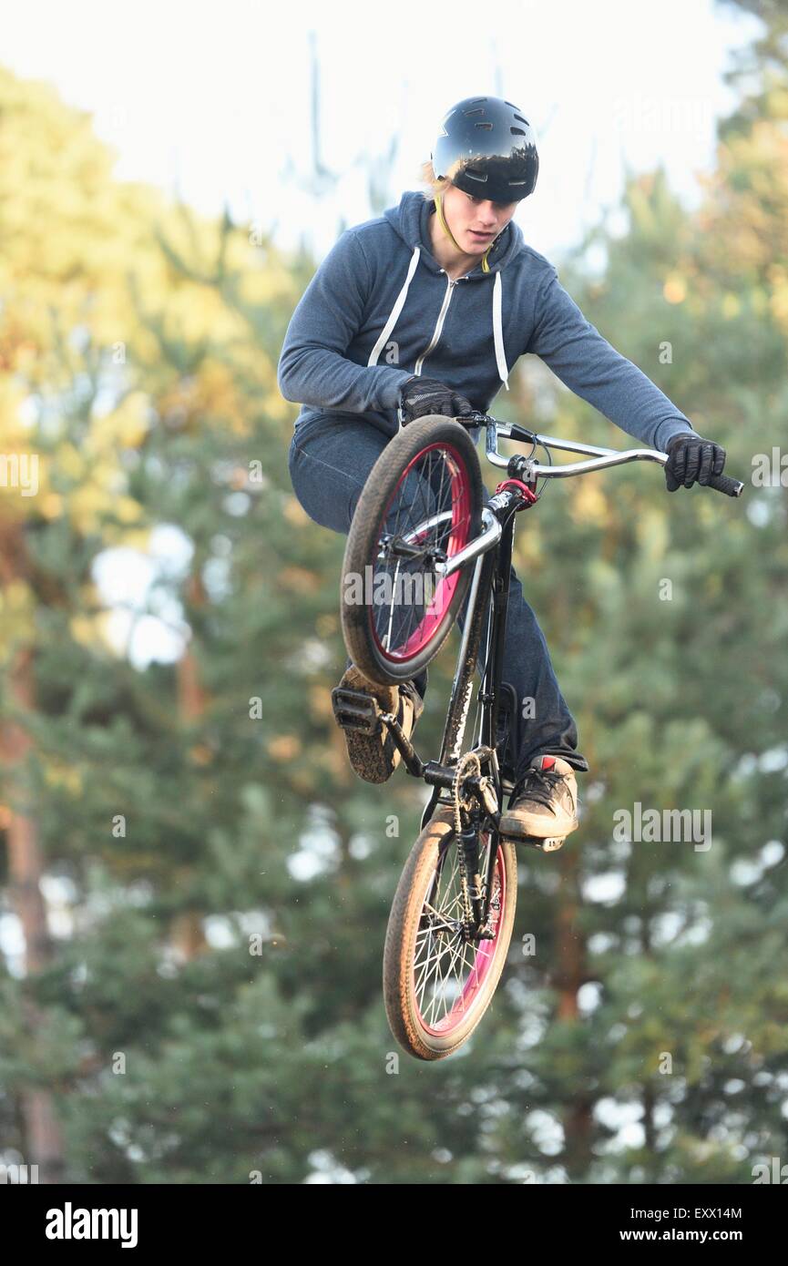 Teenager jumping in the air with his bmx bike Stock Photo