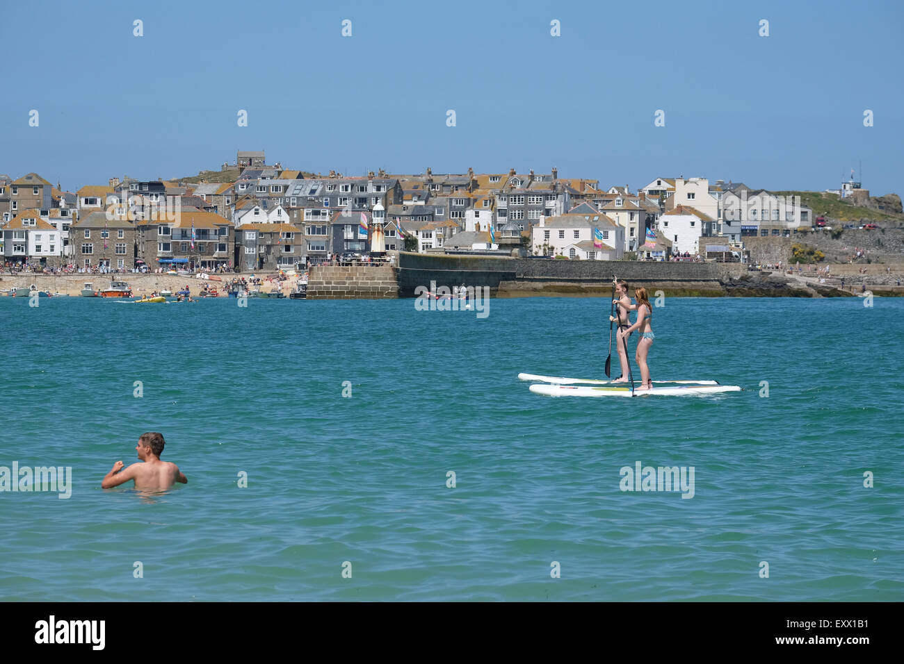 Summer sea paddleboard swim cornwall hires stock photography and