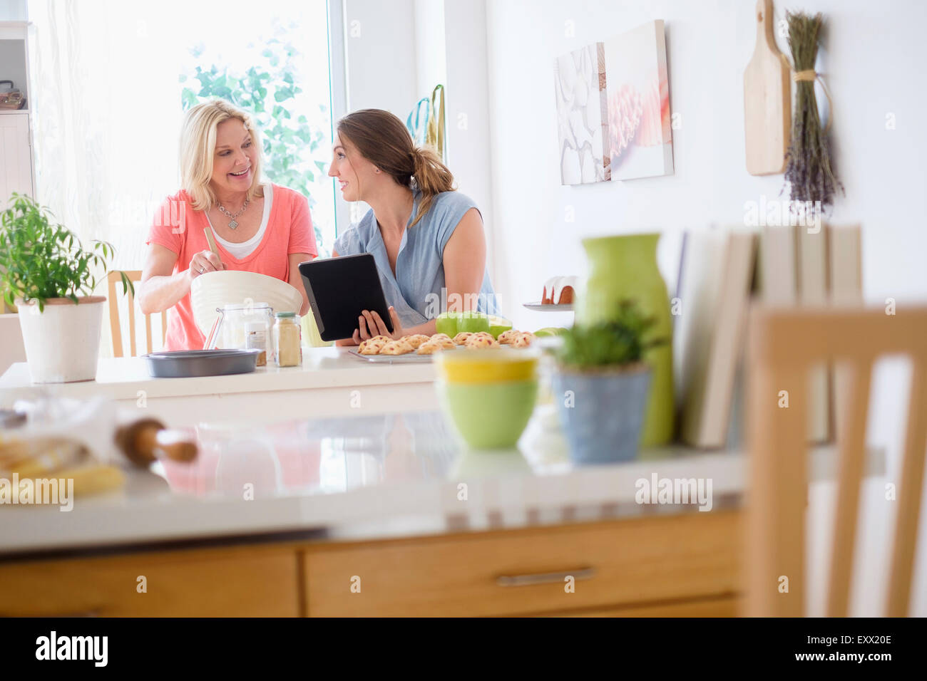 Mother with adult daughter baking in kitchen Stock Photo