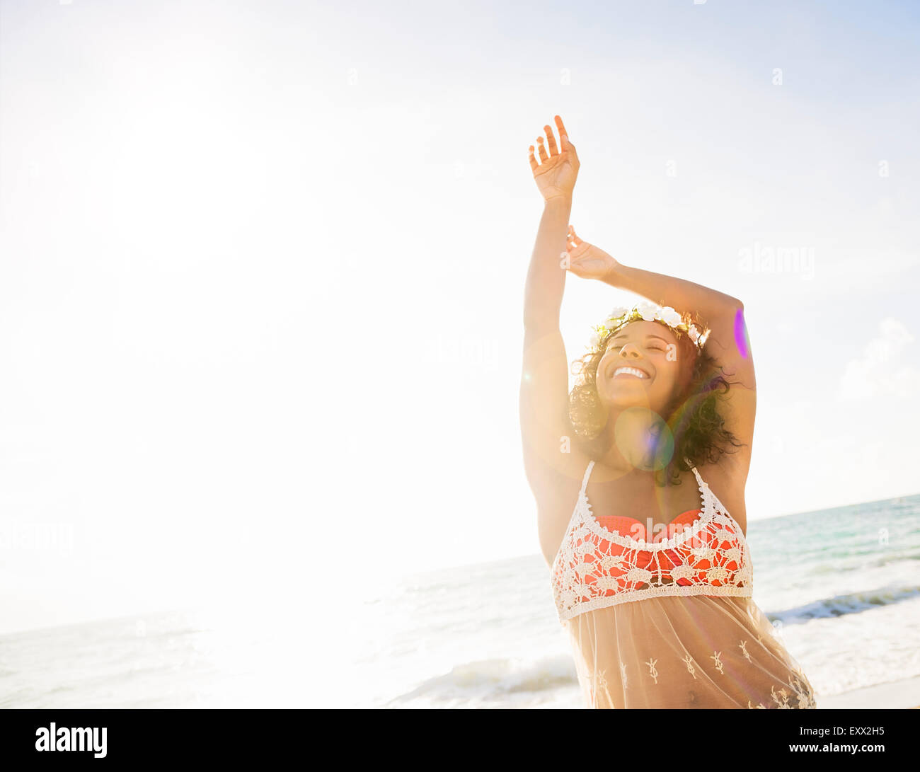 Young woman smiling on beach Stock Photo - Alamy