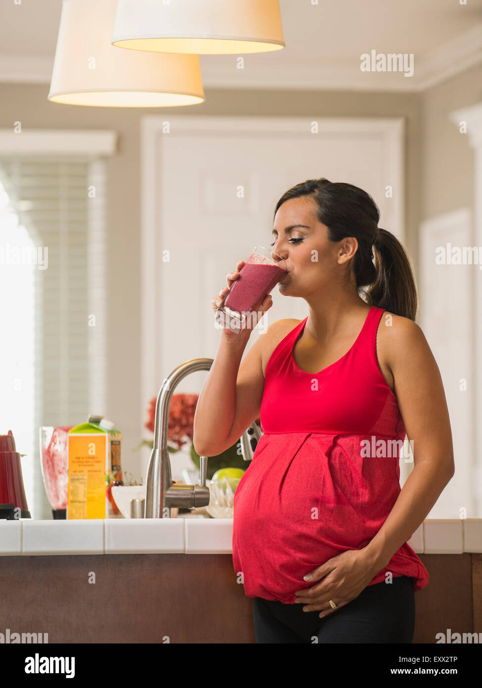 Portrait of pregnant woman drinking fruit cocktail Stock Photo