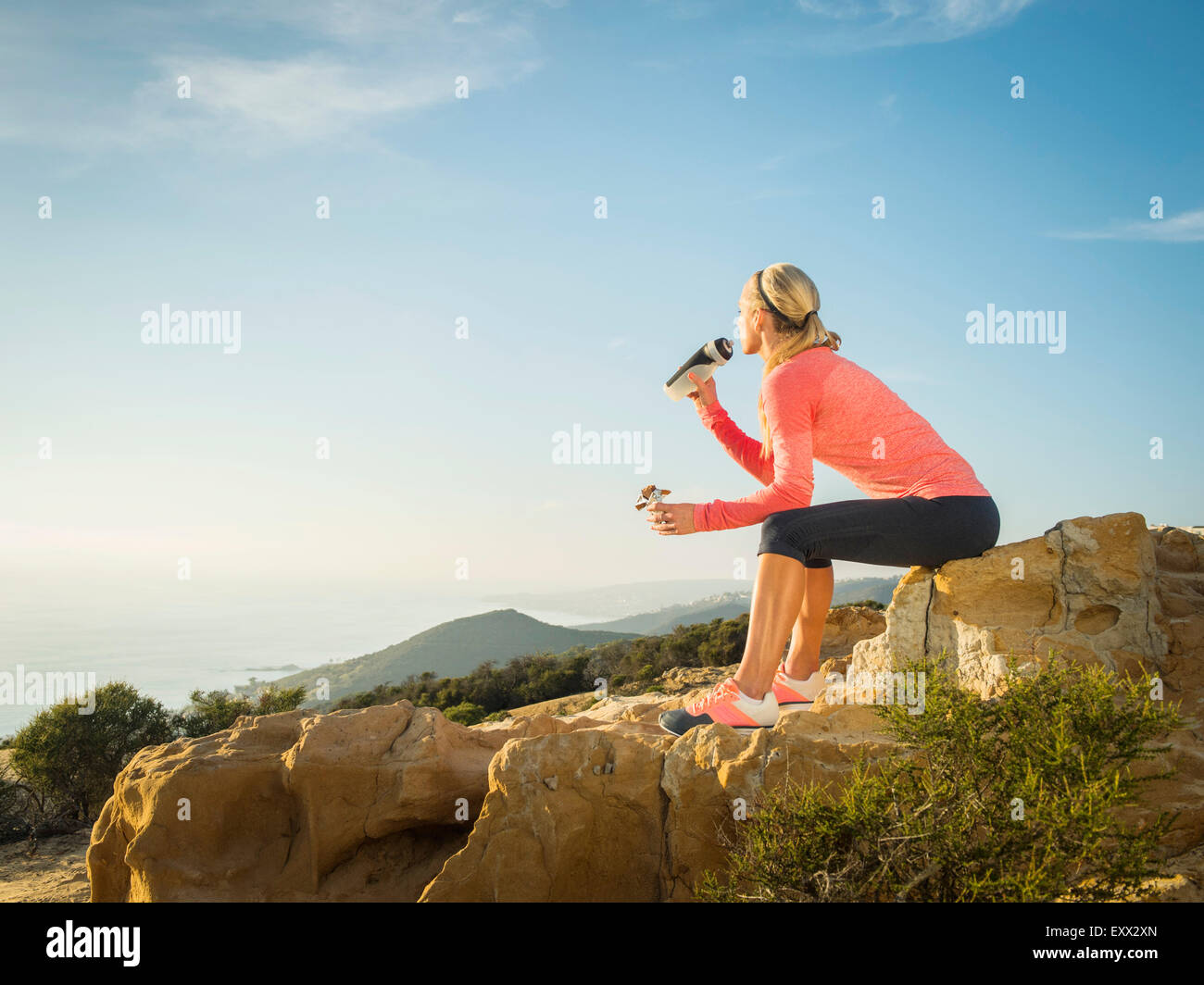 Woman in sportswear drinking water Stock Photo