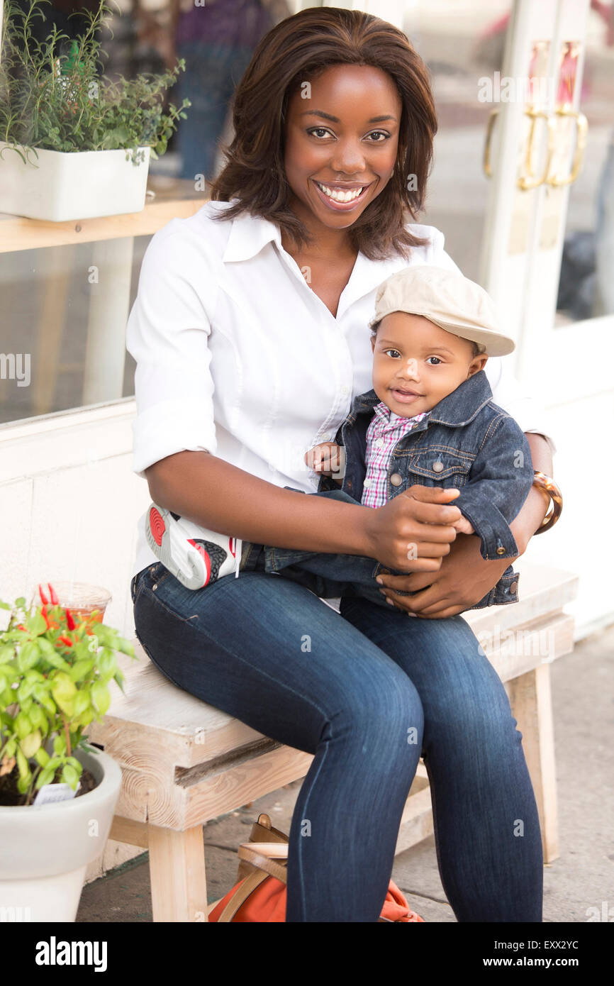 Portrait of smiling woman holding son (12-17 months) Stock Photo