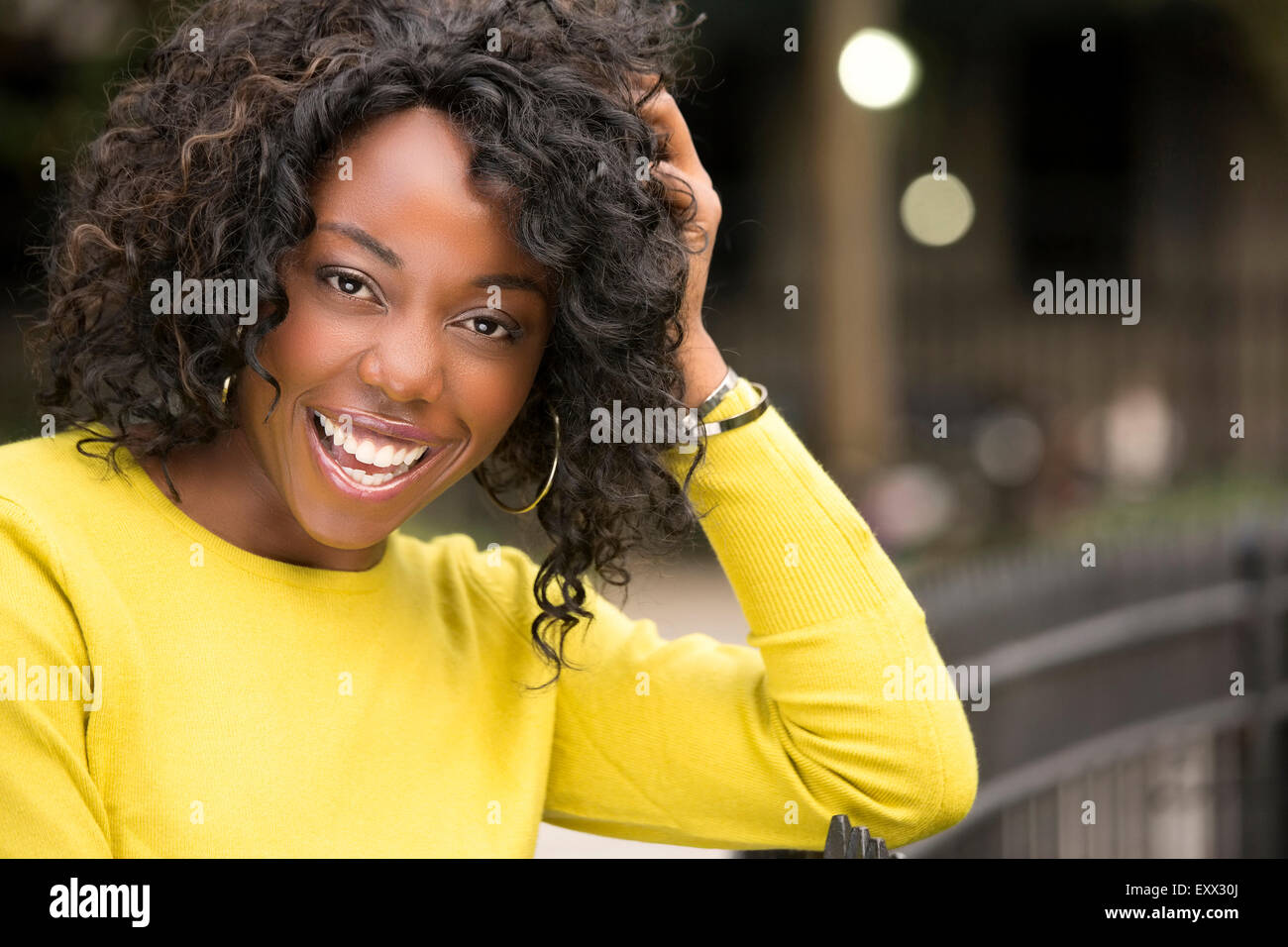 Smiling woman with hand in hair Stock Photo