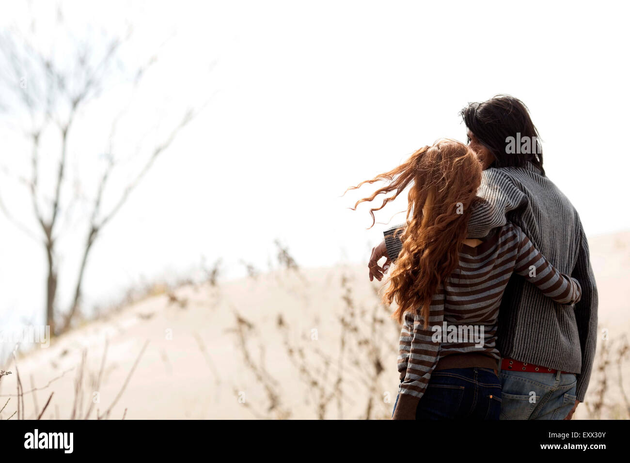 Couple standing on beach Stock Photo