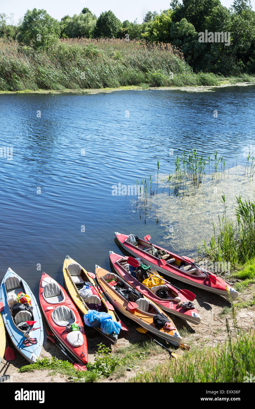 Canoes on a river-bank. Rafting on the Vorskla River. Stock Photo