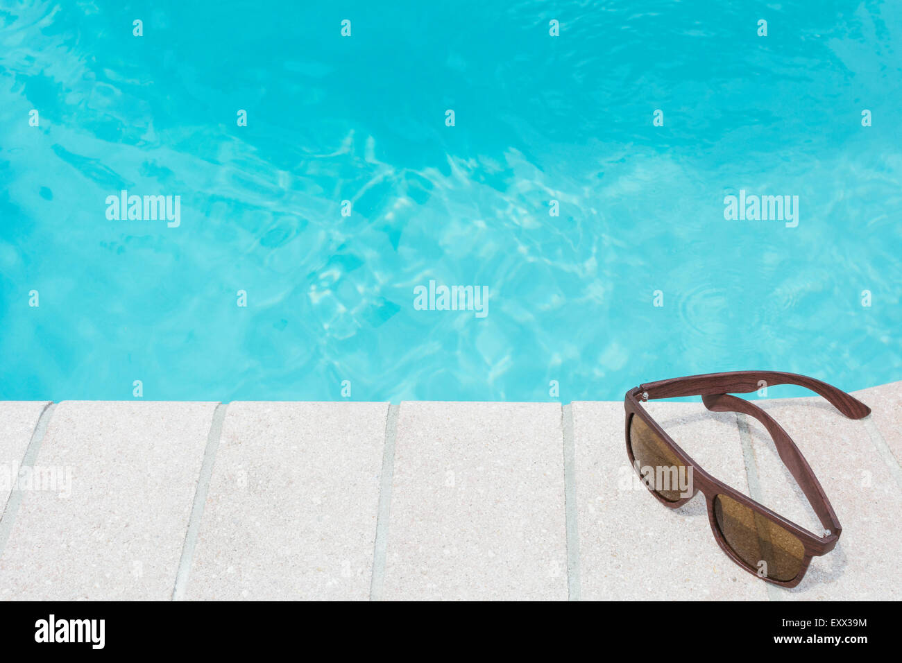 Sunglasses on pool side Stock Photo