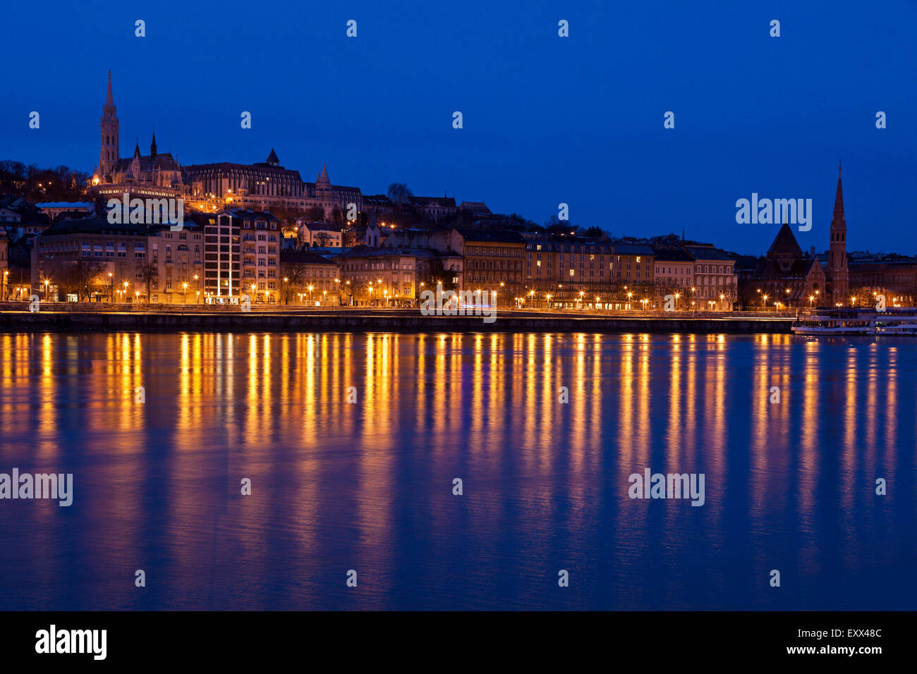 Illuminated skyline reflecting in Danube River Stock Photo