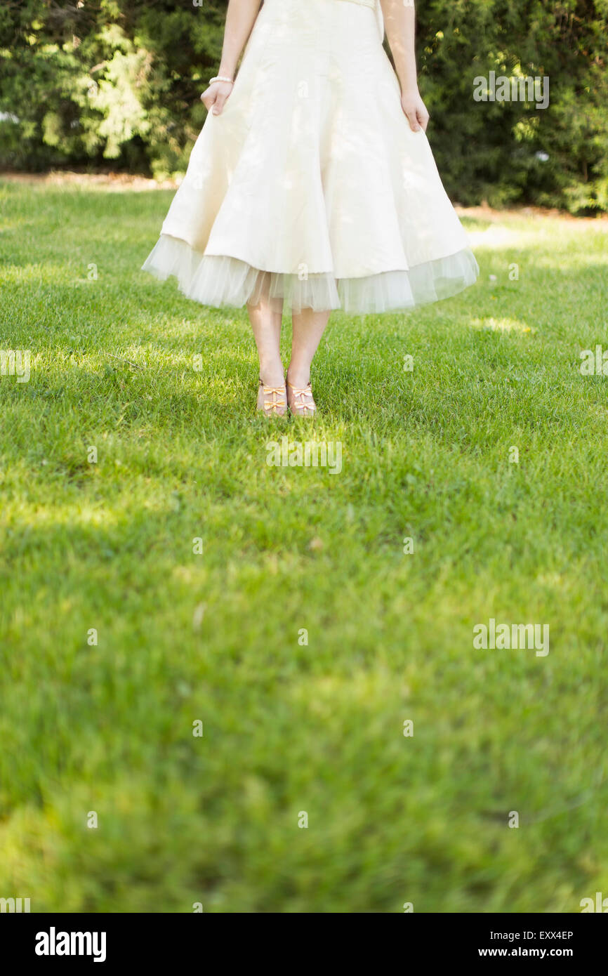 Woman in white dress standing hi-res stock photography and images - Alamy