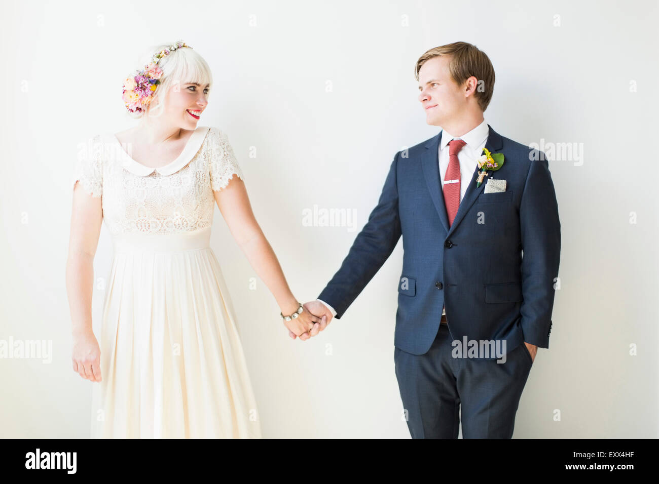 Smiling newlywed couple in studio Stock Photo - Alamy