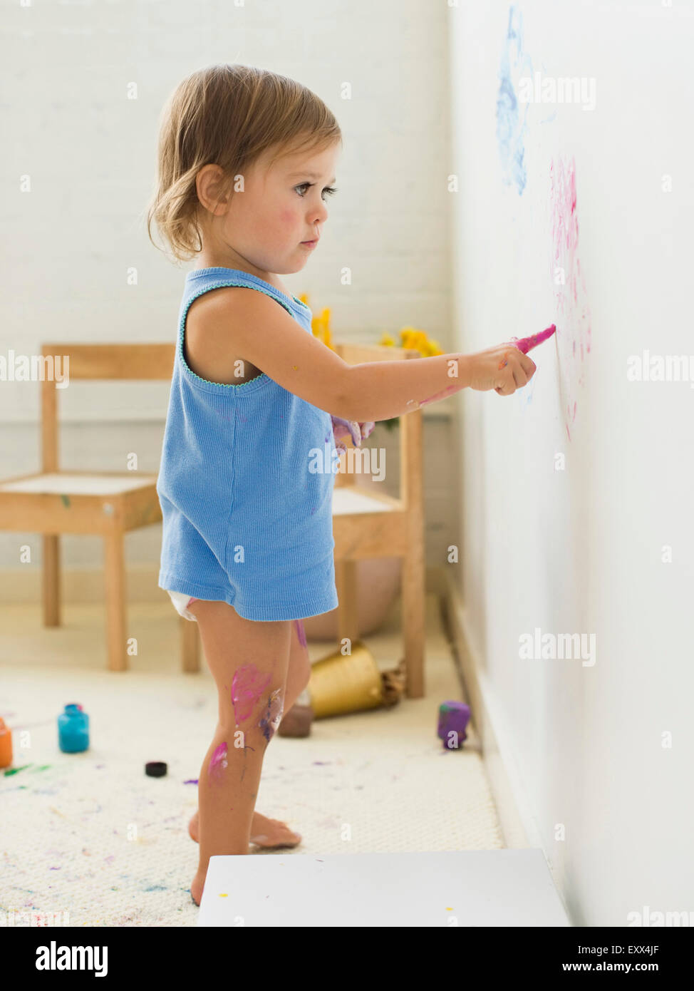 Girl (23) painting on wall Stock Photo Alamy