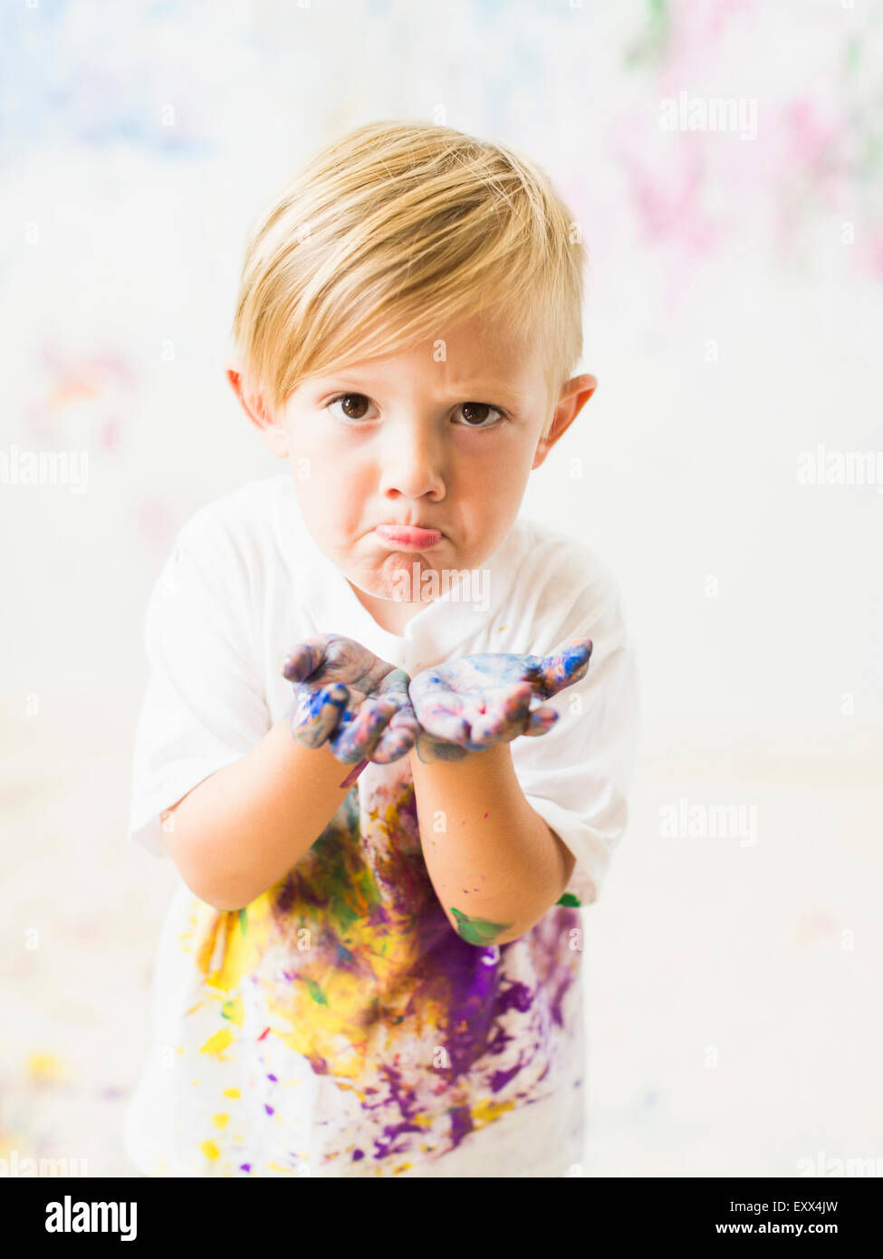 Boy (2-3) showing hands in paint Stock Photo
