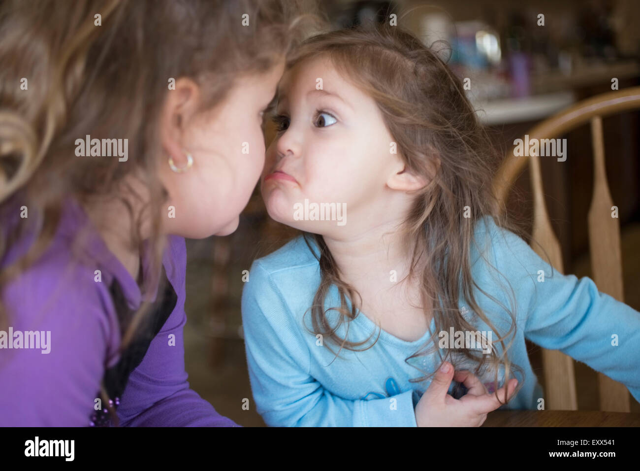 Sisters making faces at each other Stock Photo