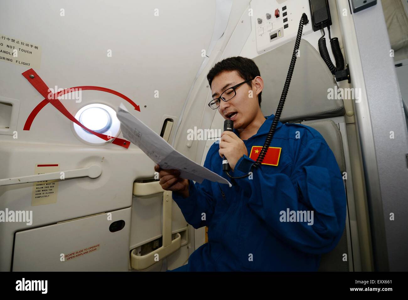 (150717) -- XI'AN, July 17, 2015 (Xinhua) -- Engineer Jin Xing introduces the ARJ21-700 jet to passengers during a demonstration flight in Xi'an, capital city of northwest China's Shaanxi Province, July 17, 2015. The ARJ21, short for Advanced Regional Jet for the 21st Century, is a type of regional airliner designed and manufactured by the Commercial Aircraft Corporation of China (COMAC). Over twenty representatives were invited on Friday to experience the one-hour demonstration flight and give feedbacks so as to help improve the overall performance of the jet. (Xinhua/Li Yibo) (mp) Stock Photo