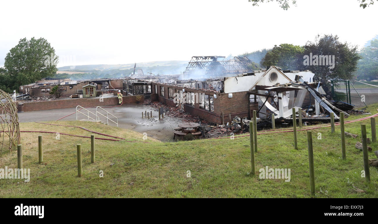 Lake, Isle of Wight, Hampshire, UK. Friday 17th July, 2015. GV Showing Daylight has made clear the destruction caused by a large blaze that has gutted a school in Lake this morning (Friday). Fifty fire crews from across the Island have been tackling a blaze at Island Learning Centre on Manor Road, Lake since midnight after it appears a mini-bus fire spread to the school building. The former Broadlea Primary School has been completely destroyed. Credit:  uknip/ Alamy Live News Stock Photo