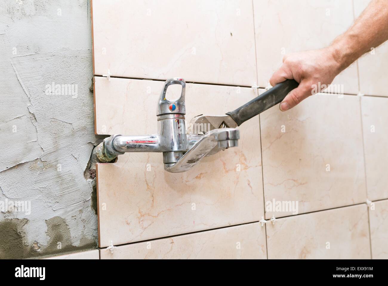 Plumber hands fixing water tap with spanner Stock Photo Alamy